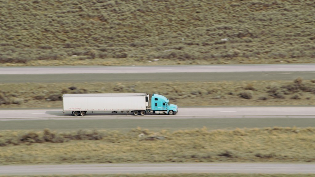 Aerial view of a semi-truck driving on a U.S. interstate highway