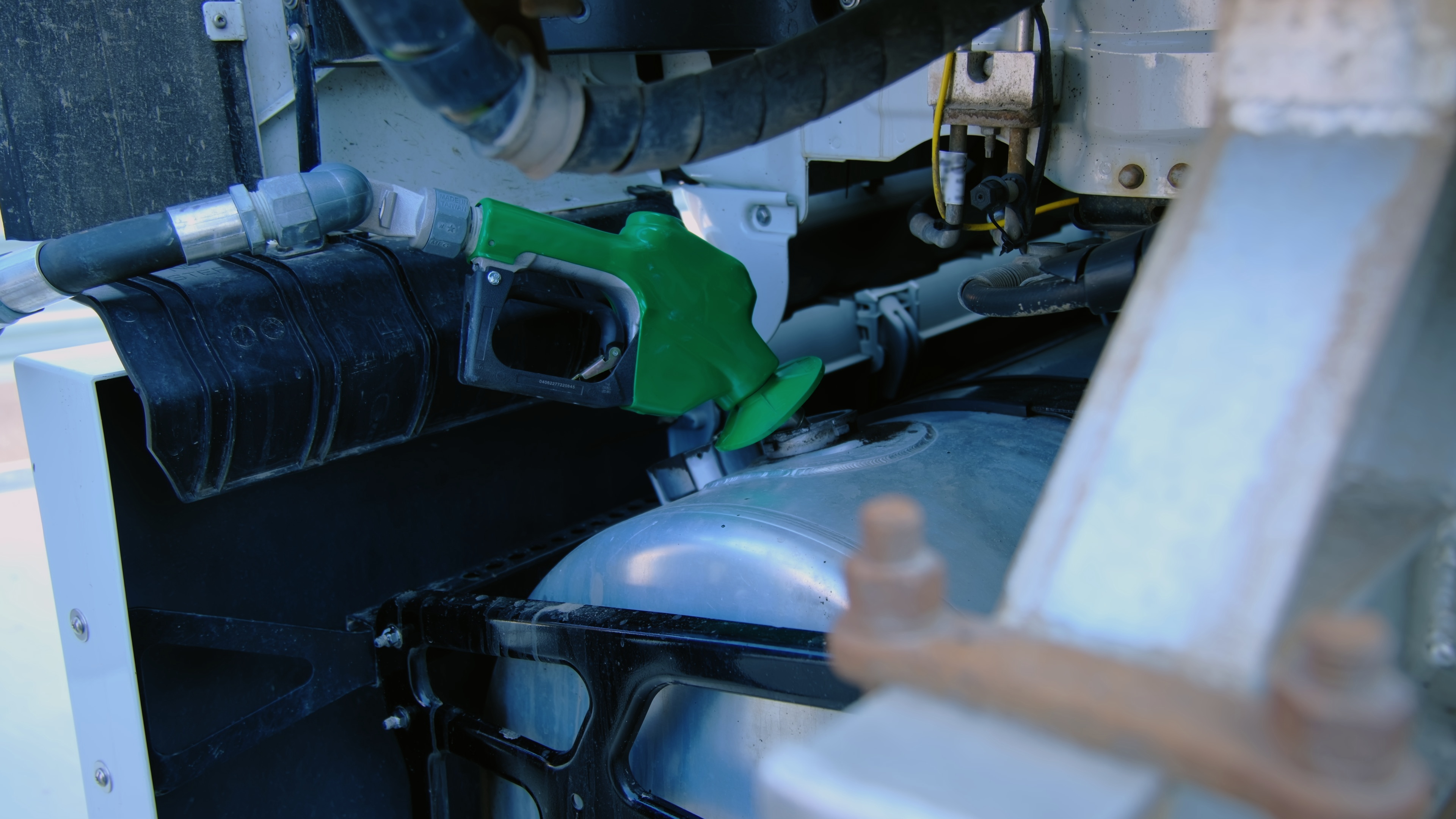 Truck driver at service station representing cooling system maintenance and fluid checks