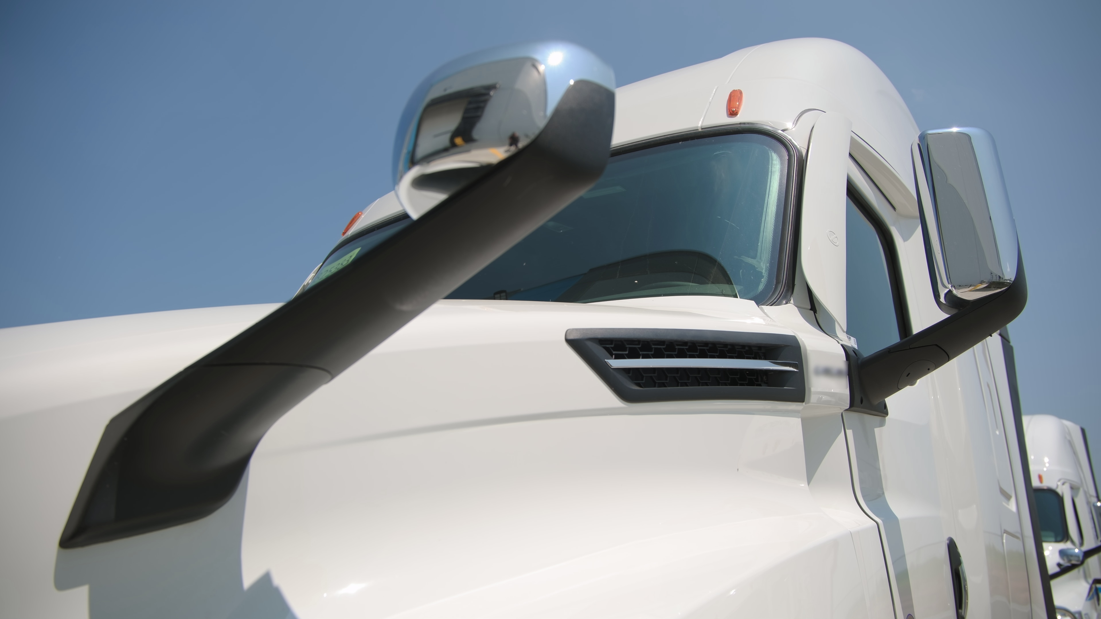 White Class 8 truck staged at a fleet terminal