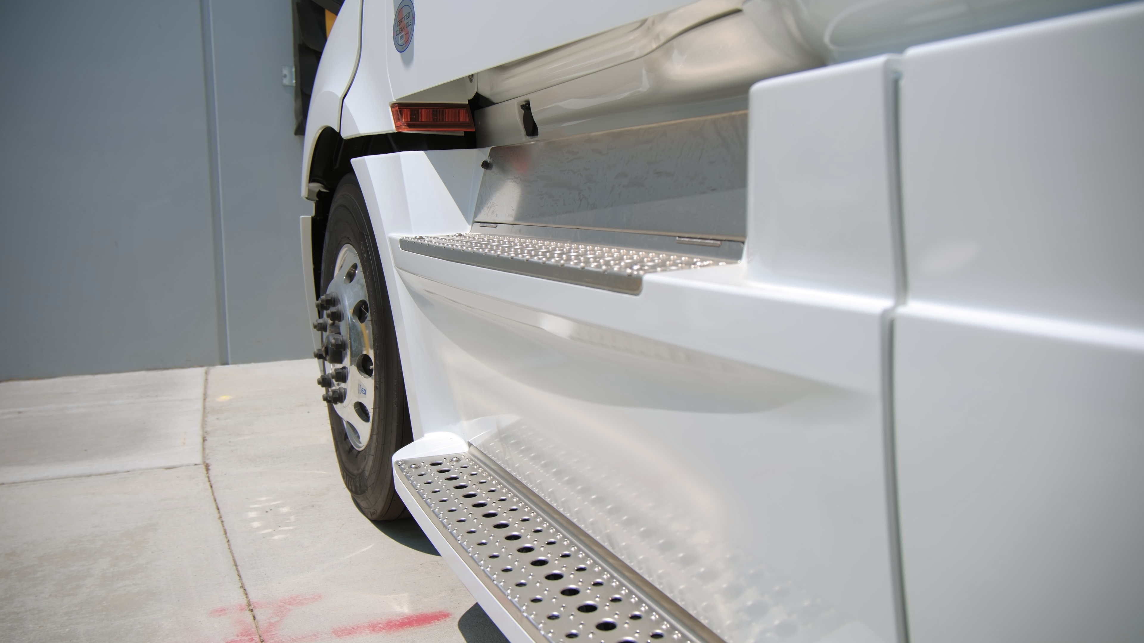 White semi-truck parked in a commercial lot