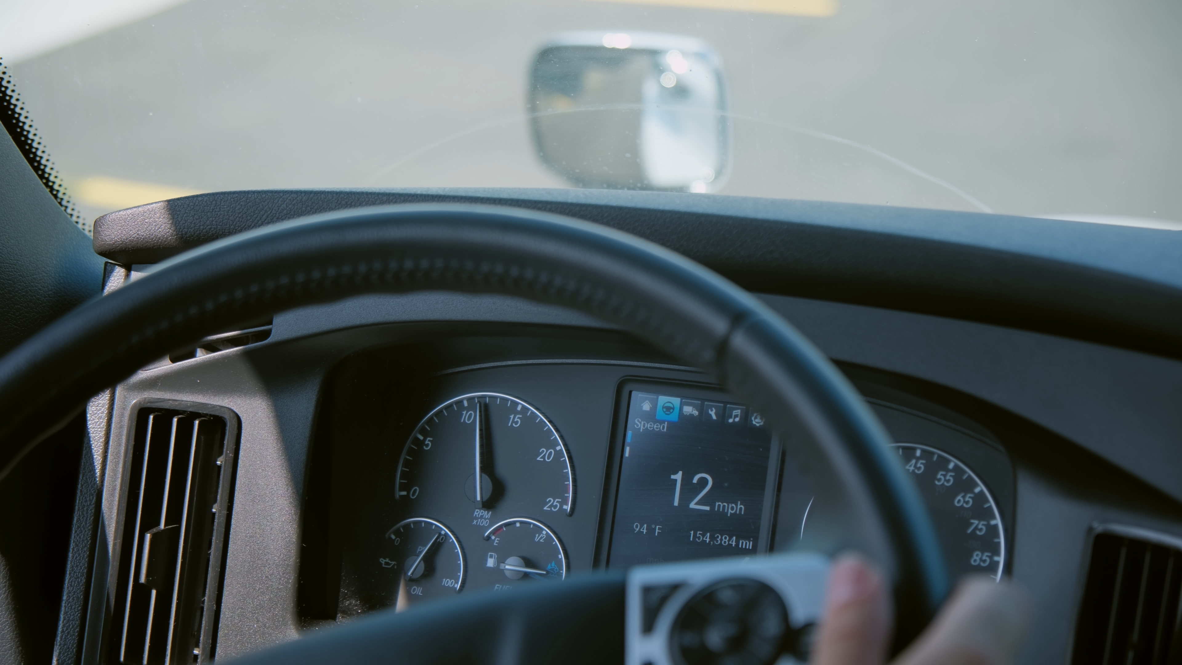 Independent owner-operator in his truck cab between loads