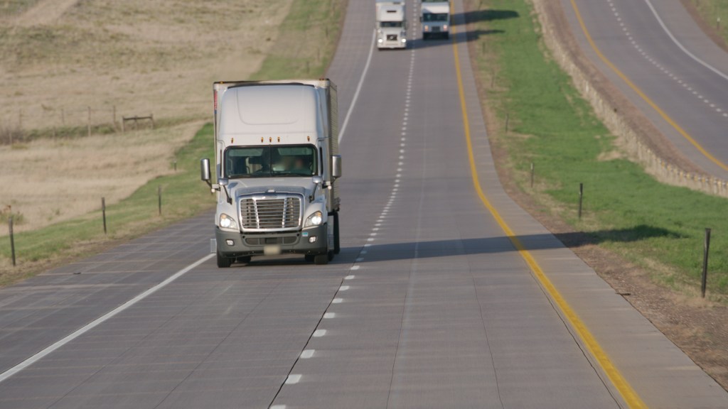 Semi-trucks driving on a U.S. highway in the shipping industry