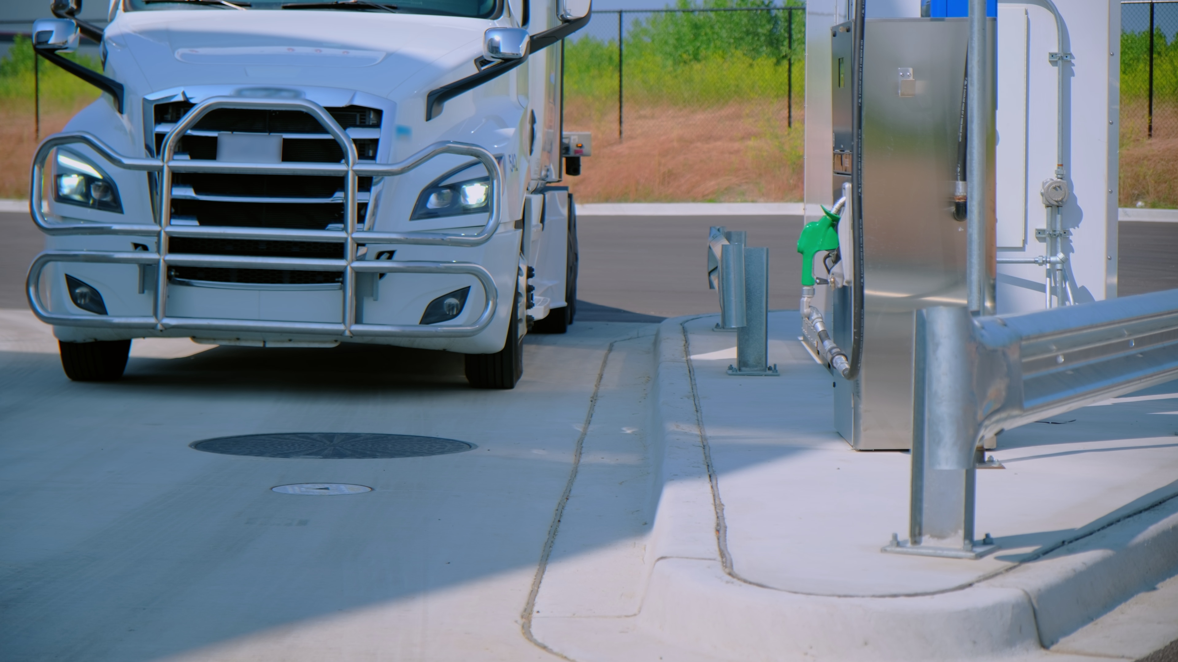Semi-truck refueling at a fuel-station gas pump