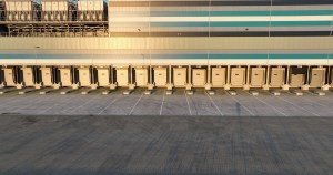 Trucks loading and unloading at a distribution-center deck platform