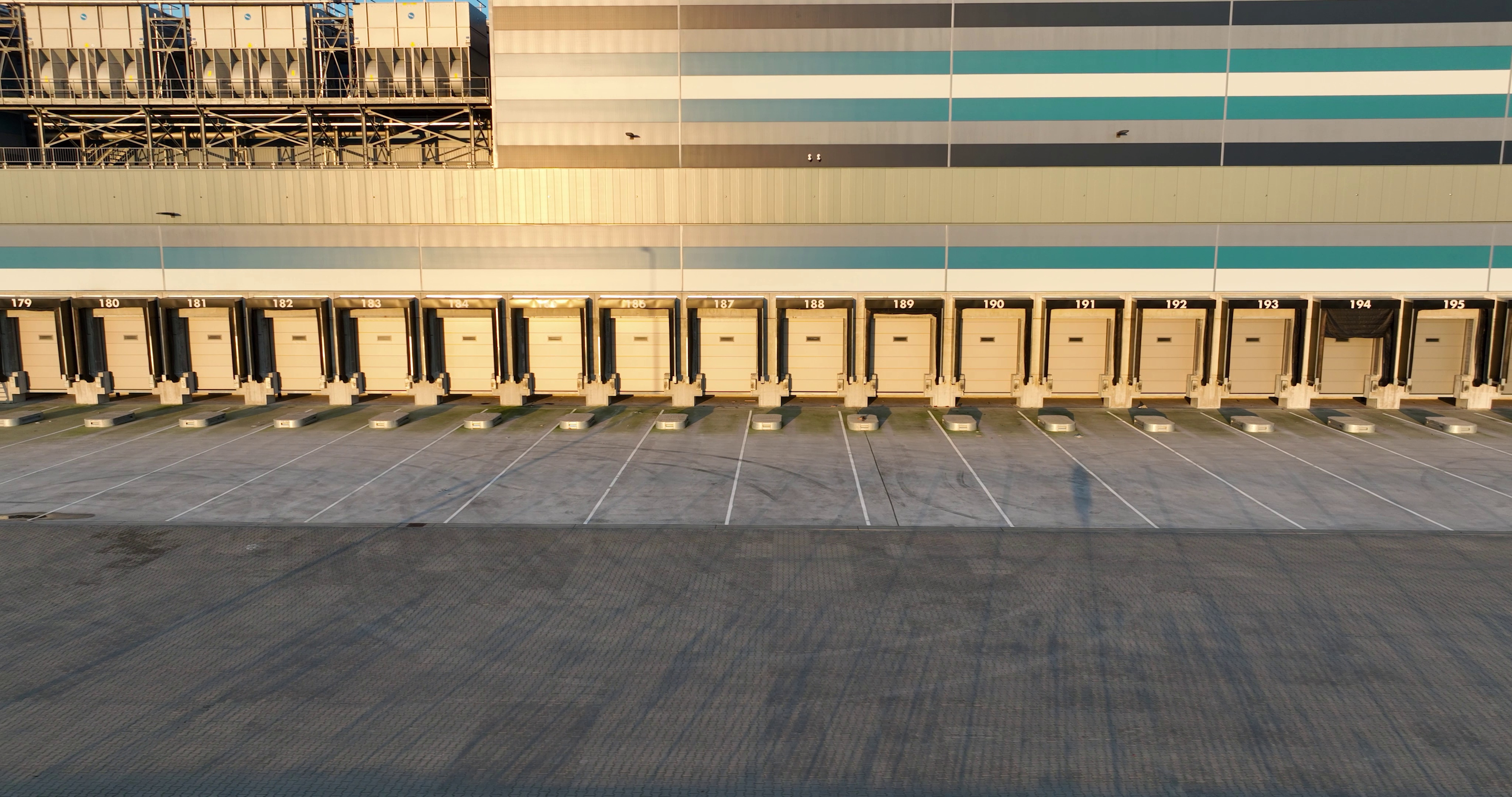 Trucks loading and unloading at a distribution-center deck platform