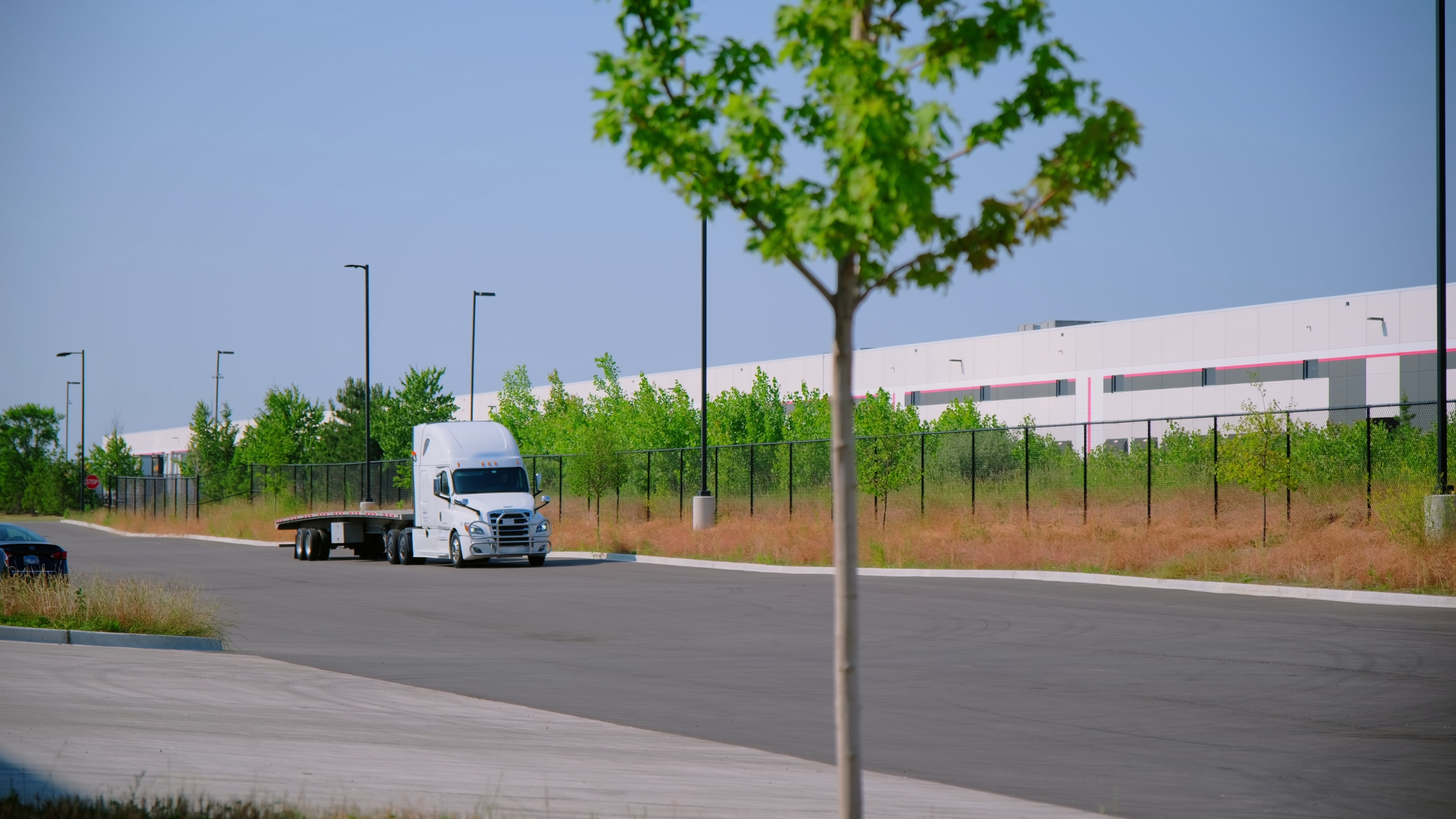 Moving white semi-truck on a highway, illustrating the regional long-haul use case for hydrogen fuel cell Class 8 deployment