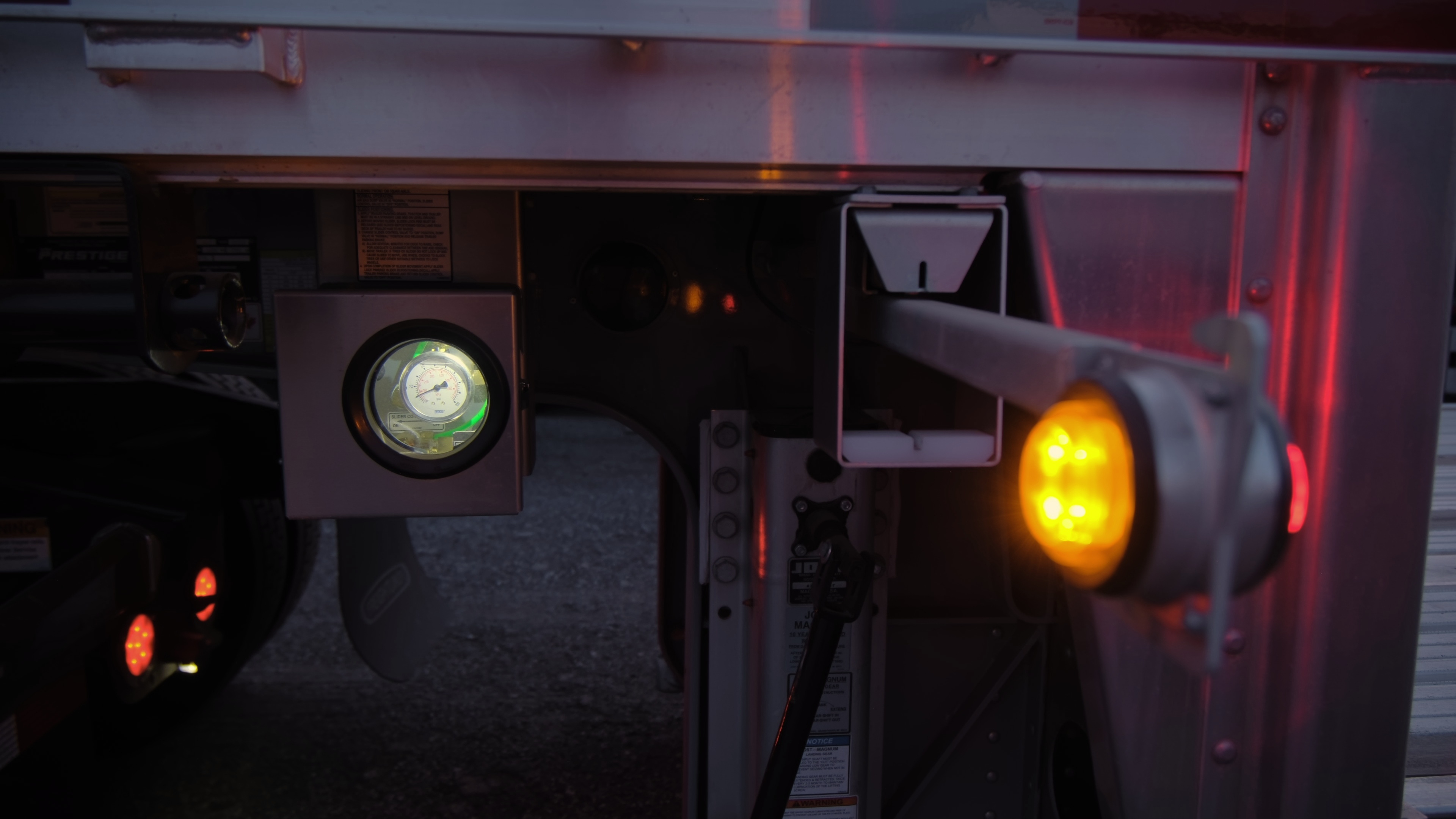 Semi-truck pulling into a parking space alongside other Class 8 trucks